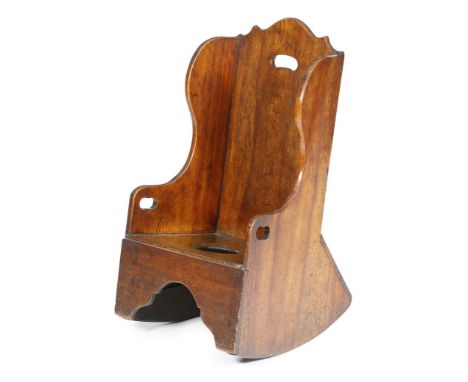 A fruitwood child's rocking commode chair, pierced with three handgrips, possibly Welsh, late 18th / early 19th century, with