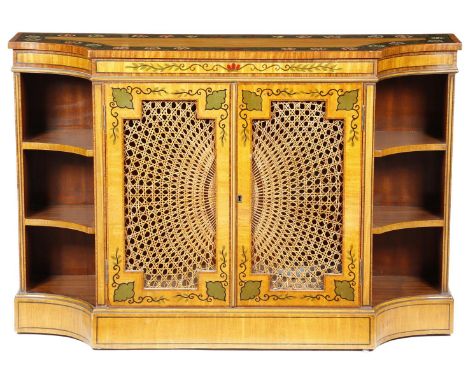 A mahogany and painted side cabinet in Regency style, the top painted with a band of flowers, above a pair of cane panelled d