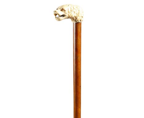 λ A Victorian walking cane, the ivory handle carved with a growling dog's head, with glass eyes, above a Malacca shaft, 96cm 