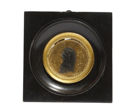 A late 18th century verre églomisé portrait silhouette, of a man, 4cm diameter, in an ebonised frame.click  here to view the 
