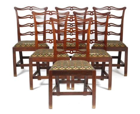 A set of six George III mahogany dining chairs, each with a pierced ladder back, on moulded and chamfered front legs united b