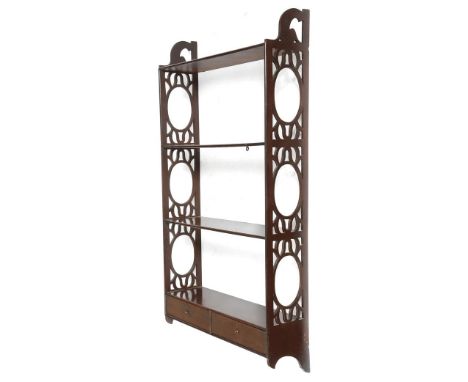 A mahogany hanging wall shelf in George III style, with pierced fretwork ends, with three shelves with applied beading, the b