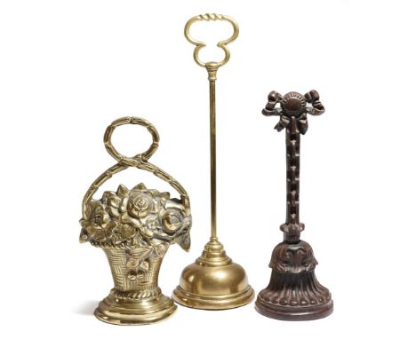 A Victorian cast iron doorstop by Kenrick & Sons, with a ribbon tied handle, stamped 'A. K. & SONS NO. 44', together with two