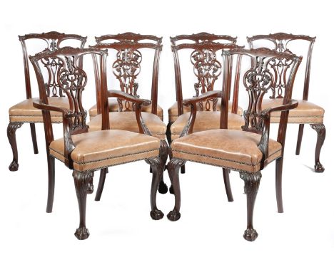 A set of eight mahogany dining chairs in Chippendale style, each with a leaf and scroll carved pierced splat back, above a st