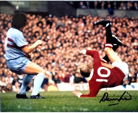 Denis Law 10x8 coloured signed photo scoring against West Ham in the early seventies. Dennis Law is a Scottish former footbal