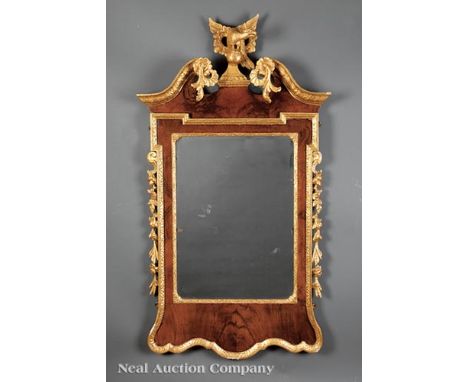 George II Walnut and Parcel-Gilt Mirror , 18th c., scrolled pediment with rosettes centering a spreadwing eagle, beveled mirr