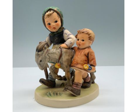 Presents a pair of pastoral children accompanied by a goat. Goebel backstamp. M. I. Hummel impressed on the round base. 334. 