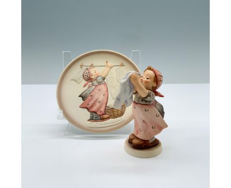 Hand painted porcelain set with matte finish features a figurine with a matching miniature plate of a little girl hanging clo