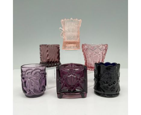 Vintage holders feature a variety of intricately designs, colored glass holders. Showcases hues from deep purple to midnight 
