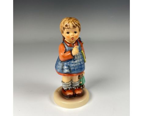 Hand decorated exclusive special edition figure of a young girl holding a book and a doll. Artist impressed signature in the 