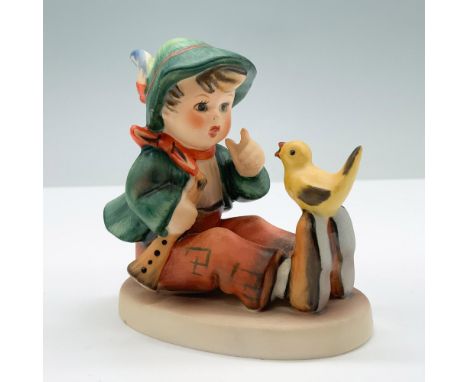 Hand painted porcelain figure of a kid with a little bird. Goebel backstamp. M. I. Hummel impressed on the round base. 63. Di