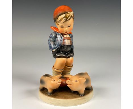 Hand decorated figure of a farm boy with pigs symbolizing wealth, good fortune and prosperity in Germany. Artist impressed si