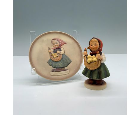 Hand painted porcelain set with matte finish features a figurine with a matching miniature plate of a little girl holding a b