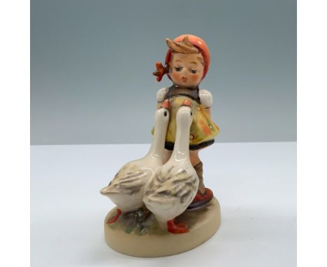 Hand painted porcelain depicts a little girl dressed in an apron and polka-dot kerchief, leaning back with flowers hidden beh