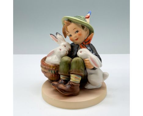 Hand painted porcelain piece in matte finish. features a little young boy playing with his white rabbits. Goebel backstamp. M