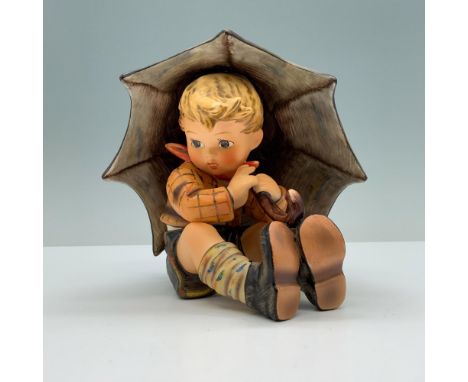 Hand painted porcelain featuring a little blonde kid sitting under an umbrella. Goebel backstamp. 152A. M. I. Hummel impresse