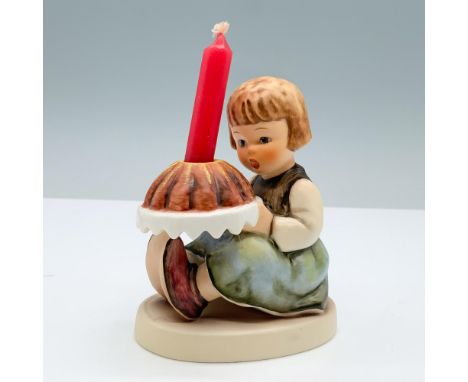Hand painted porcelain features cute figurine of a girl holding a cake. Goebel backstamp. M. I. Hummel impressed on the round