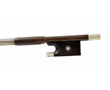 Interesting violin bow, indistinctly stamped, the ebony frog inlaid with silver rings enclosing pearl eyes, with a silver fer