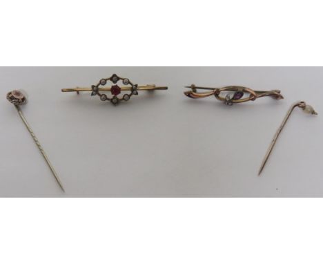 A rose gold/gilt stick pin star set with pink paste, together with a yellow metal stick pin set with a seed pearl, an unmarke