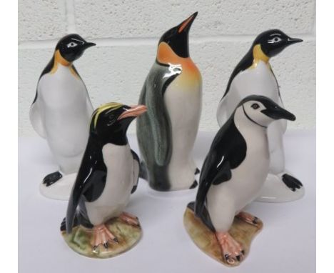 Five ceramic penguins, to include two made by Poole pottery