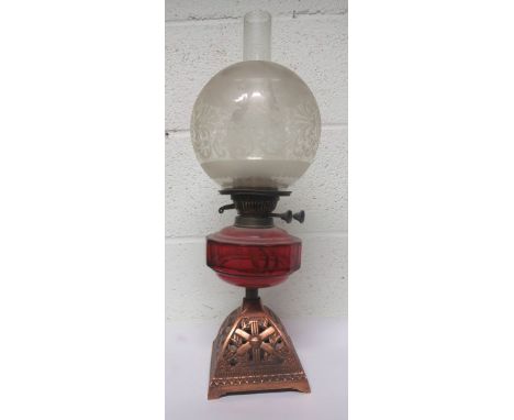 Victorian copper oil lamp, with cranberry glass reservoir together with chimney and an etched clear glass shade 