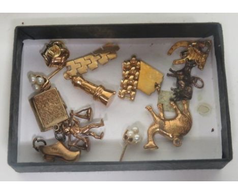 A collection of gold charms, with two marked 375, and three testing as 9ct, gross weight 10g, together with two unmarked char