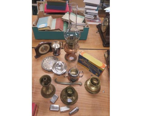 Quantity of general miscellanea to include lighters, a mantel clock, silver plate, oil lamp bases etc