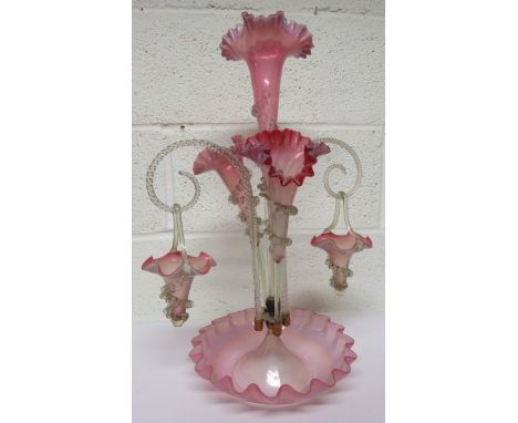 A Victorian light cranberry and light blue glass three flute epergne, a central flute surrounded by two smaller ones with cle