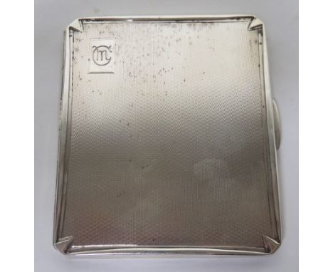 Silver cigarette case with engine turned design and the initials M.C engraved to the top right, weight 3.9ozt