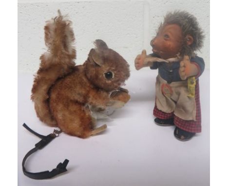 Steiff Hedgehog in original costume and with labels, 17cms high together with a Steiff squirrel holding a nut, cinnamon tippe