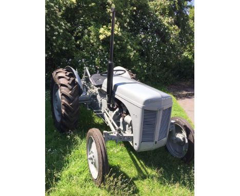 A 1951 Ferguson TEA20 tractor painted grey, 6 volt petrol with two furrow plough, nine hole draw bar, stabilisers with origin