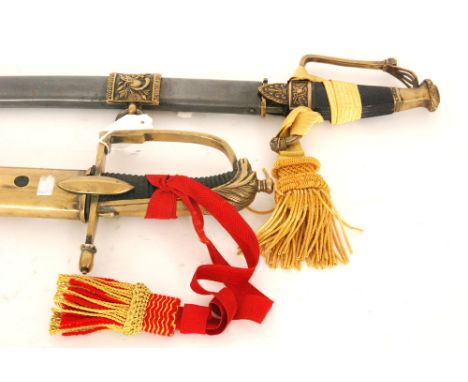 A 20th Century German officer's sabre, the curved steel blade engraved with armour and crossed halberds with floral detail an