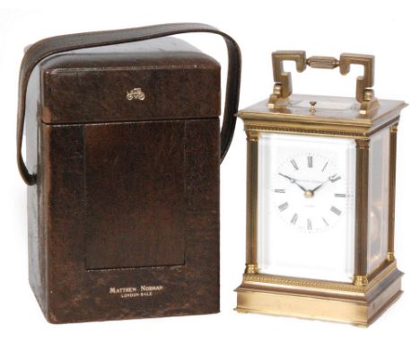 A 20th Century French brass carriage clock by Matthew Norman London with push button repeat, white enamelled dial in bevelled