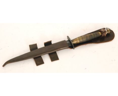 A British Commando style knife with brass handle 17.5cm blade and leather scabbard.