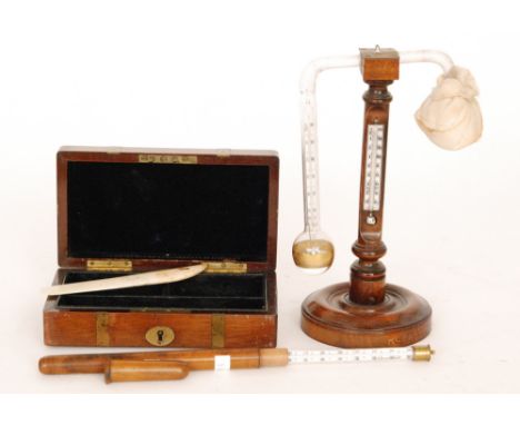 A 19th Century hydrometer/thermometer on a turned walnut stand stamped P Harris & Co Birmingham, height 24cm, a Cookes patent