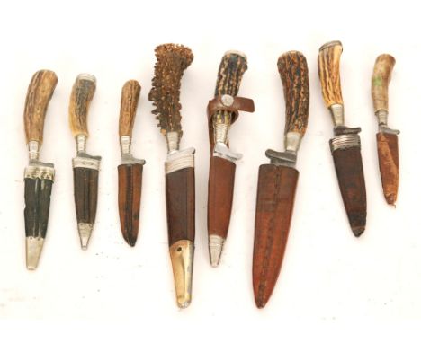 A German hunting knife and scabbard with naturalistic horn handle, the 12cm blade stamped Rostfrei Solingen, another dated 19