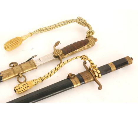 A 20th Century naval short sword with leather and brass scabbard, leather grip and lion pommel, 47cm blade and a similar side