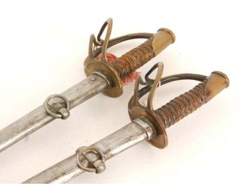 A pair of American 1865 pattern sabres, pierced brass D shaped knuckle guards each with metal scabbard, blades 87cm