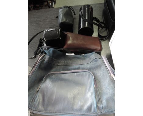 A Cannon AR-1 with 50mm lens, Panagor telephoto lens, power winder, two Cannon lenses, manual in soft carry bag 