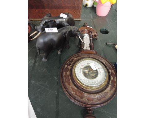 A pair of ebony eliphants and a barometer