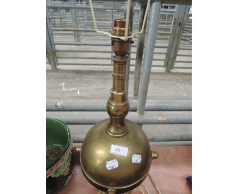 A vintage brass table lamp, possible modelled from depth charge/mine