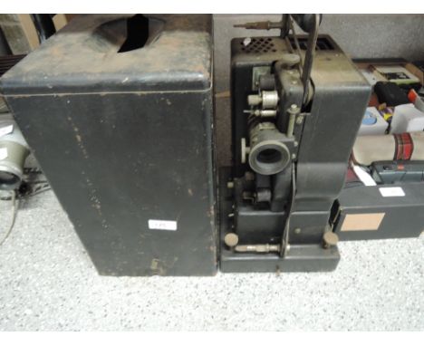 A vintage German film projector in metal carry cover