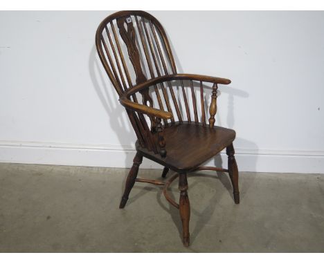 A 19th century ash and elm stick back Windsor chair - height 97cm - with a crinoline stretcher