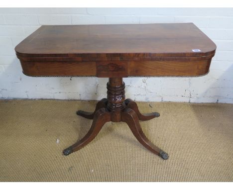 A 19th century rosewood foldover card table on a turned column and quatrefoil scroll legs - Height 71cm x Width 92cm