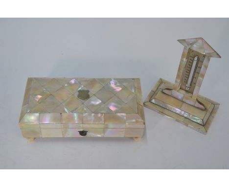 A Victorian mother of pearl jewellery casket with blue velvet fitted lining incorporating watch-stand, on turned bone feet, 1