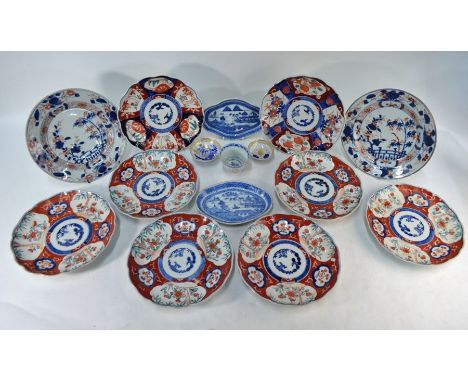 A pair of early 19th century Japanese Imari porcelain floral dishes painted in underglaze blue and iron red enamel, 23 cm dia