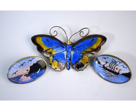 David Andersen - A Norwegian enamelled butterfly brooch with outstretched wings, 6 cm across to/w oval enamelled badges depic