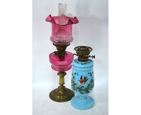 A Victorian oil lamp with cranberry glass shade and front, on brass pedestal base, to/w a turquoise opaque glass oil lamp pai