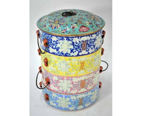 A 19th century Chinese porcelain tiffin box, tingkat, the four stacking cylindrical bowls with twisted metal handles and a do