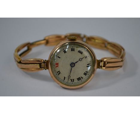 A vintage 9ct gold wristwatch with Swiss movement and silvered 22 mm dial with red enamel XII, on expanding bracelet strap st